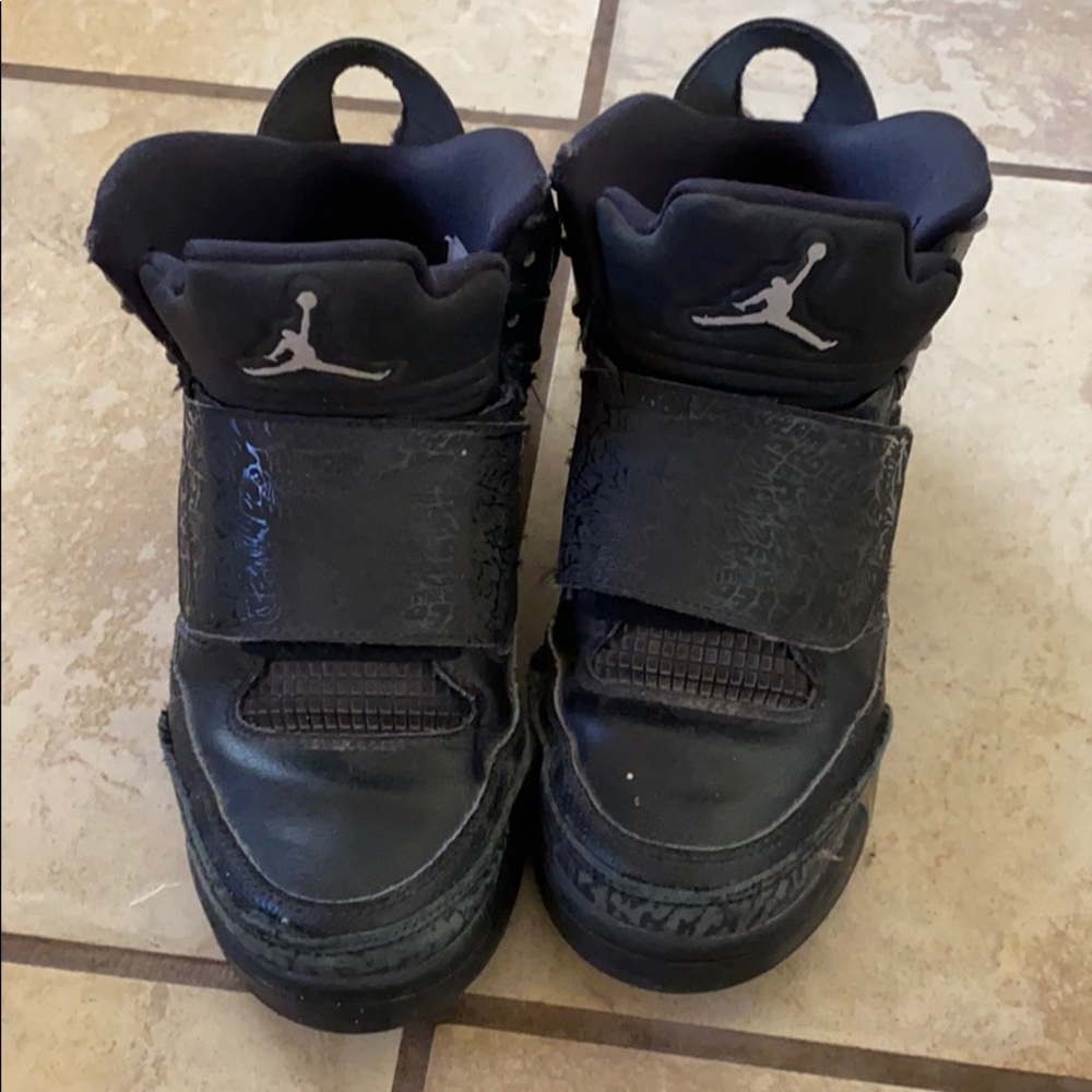 Boys son of mars black Jordans.